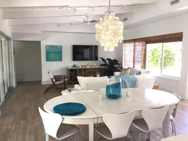 a dining room with furniture a chandelier and window