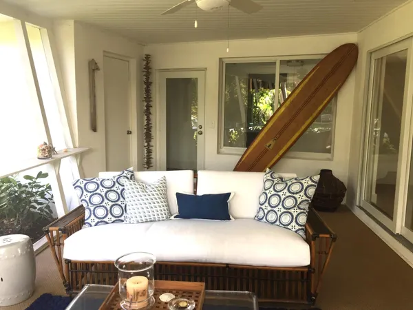 a bedroom with furniture and a large window