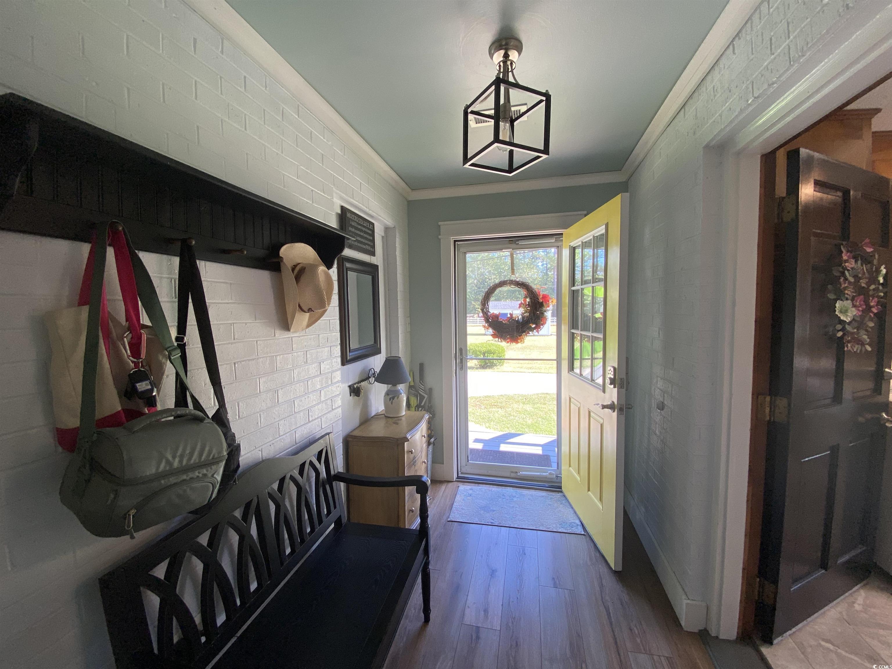 2593 Long Ave Extension Conway, SC 29526 - Photo 18 of 40 Mudroom featuring ornamental molding, wood finished floors, and brick wall