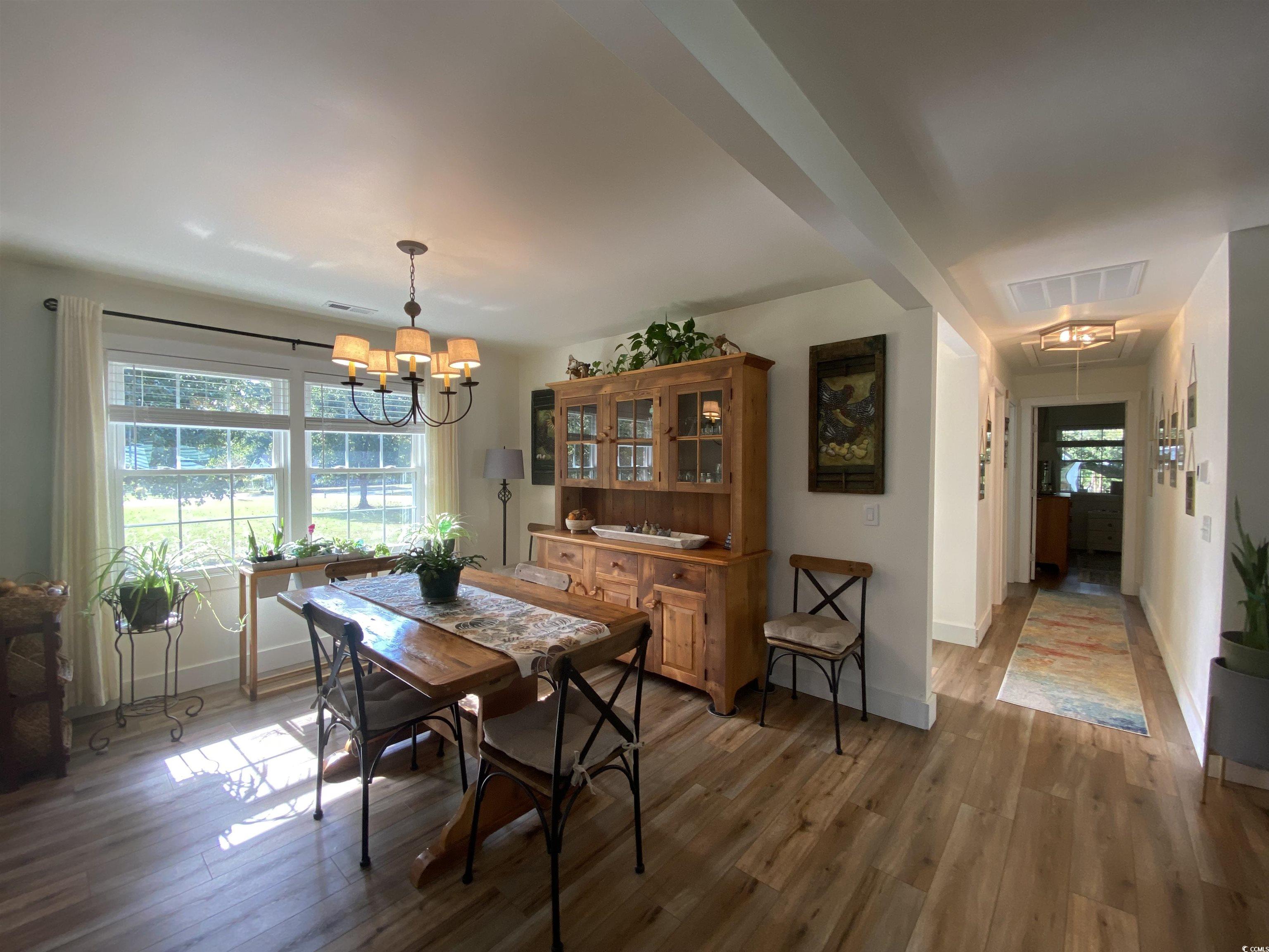 2593 Long Ave Extension Conway, SC 29526 - Photo 25 of 40 Dining area with attic access, light wood-style flooring, and a chandelier
