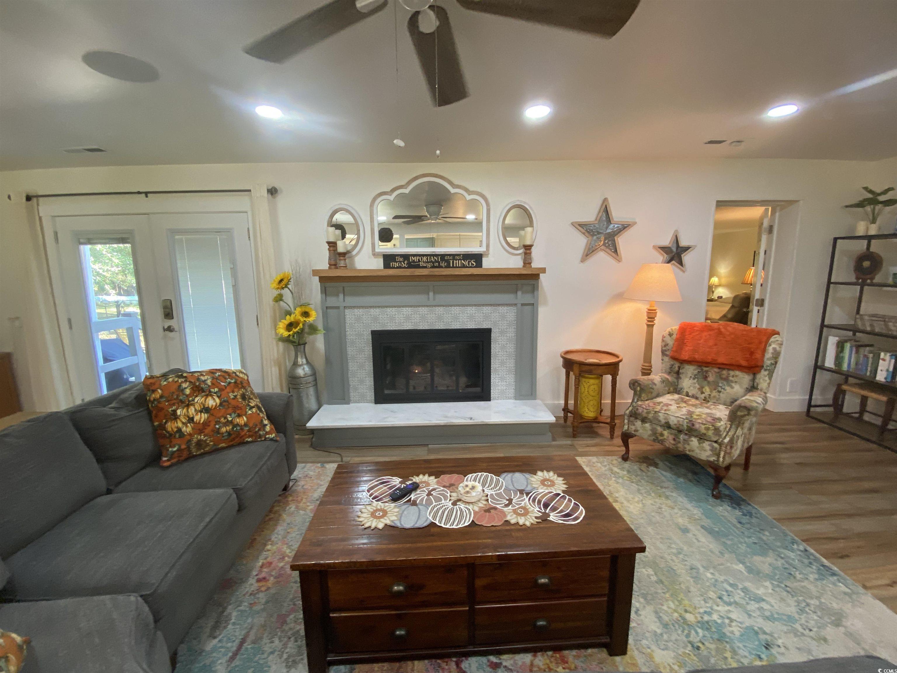 2593 Long Ave Extension Conway, SC 29526 - Photo 27 of 40 Living area featuring wood finished floors, recessed lighting, a tiled fireplace, and french doors