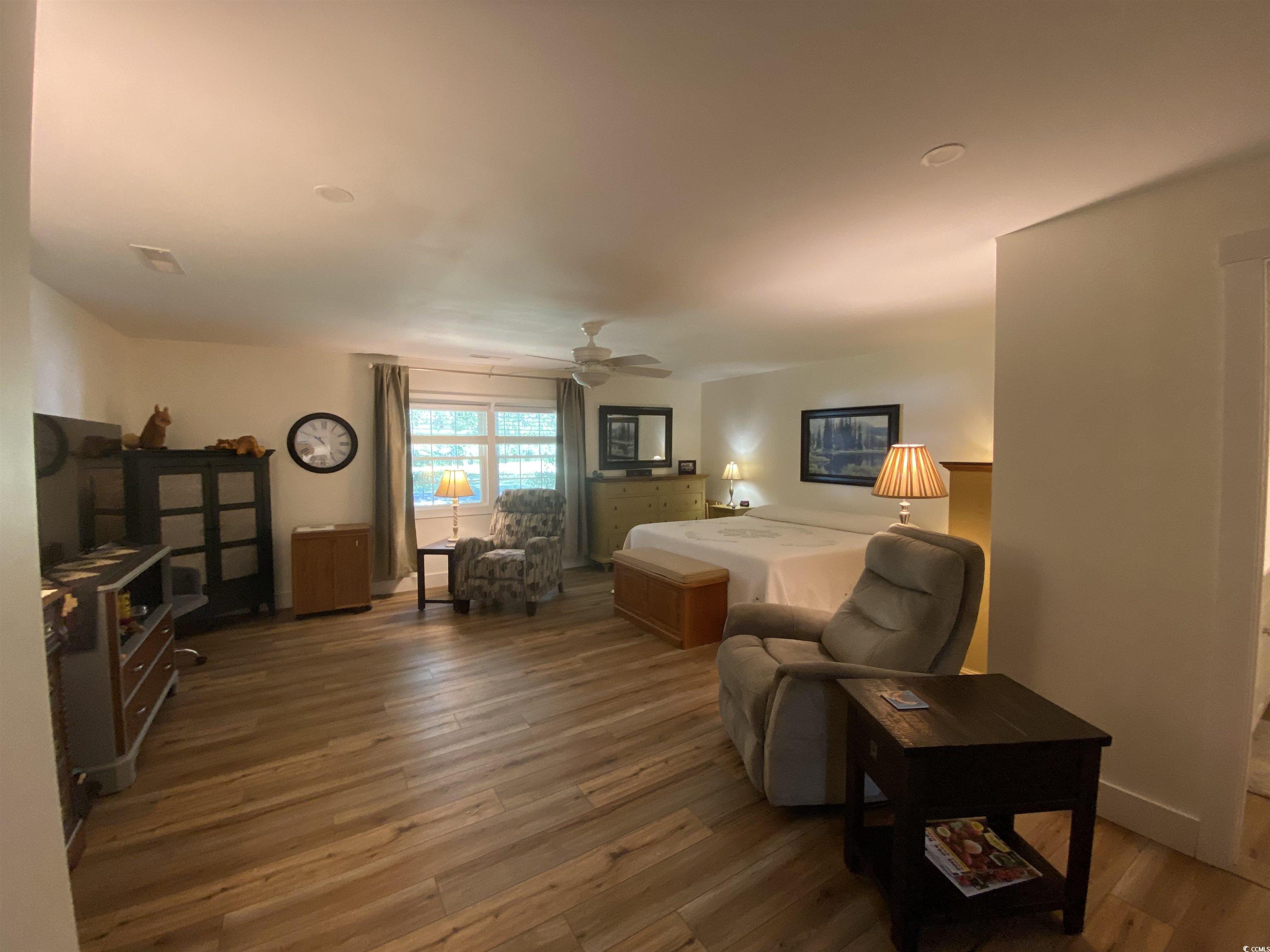 2593 Long Ave Extension Conway, SC 29526 - Photo 39 of 40 Bedroom featuring light wood finished floors, ceiling fan, and a wood stove