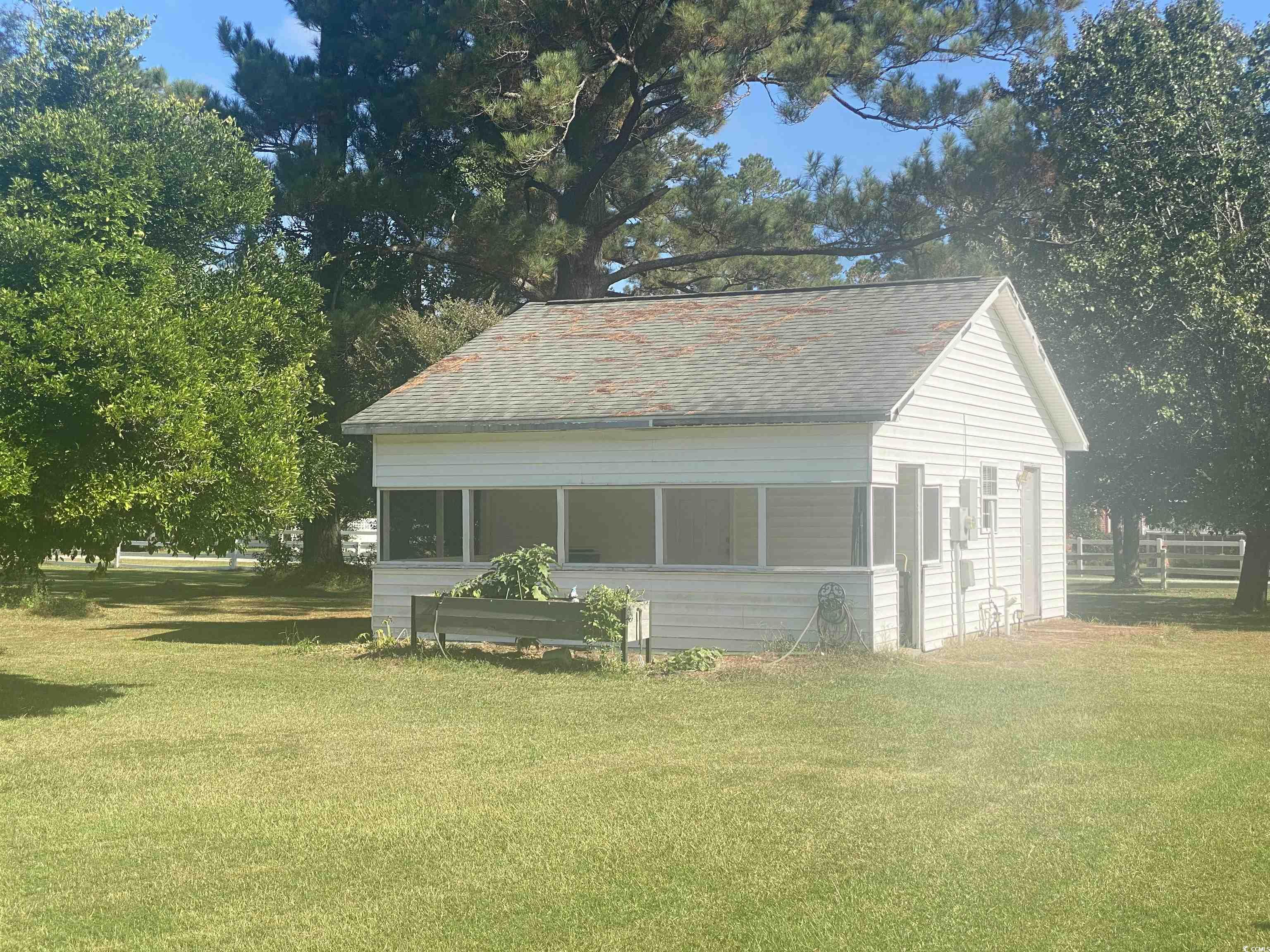 2593 Long Ave Extension Conway, SC 29526 - Photo 8 of 40 View of front facade with a sunroom and a front yard