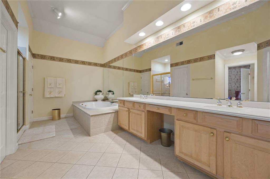 4727 Ivy Ridge Drive Southeast Atlanta, GA 30339 - Photo 15 of 35 a bathroom with a sink a toilet and shower