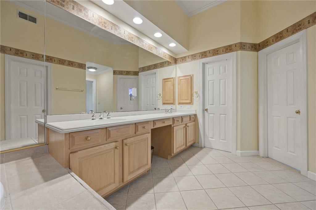 4727 Ivy Ridge Drive Southeast Atlanta, GA 30339 - Photo 17 of 35 a large bathroom with a sink mirror and a shower