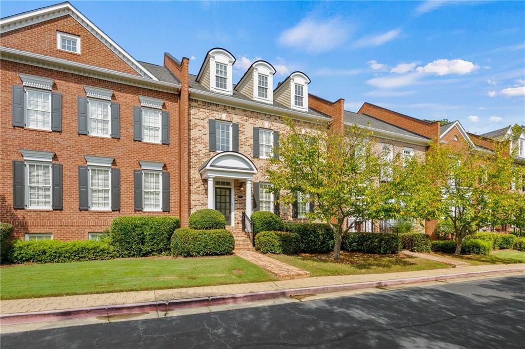 4727 Ivy Ridge Drive Southeast Atlanta, GA 30339 - Photo 2 of 35 a front view of a house with a yard and garage