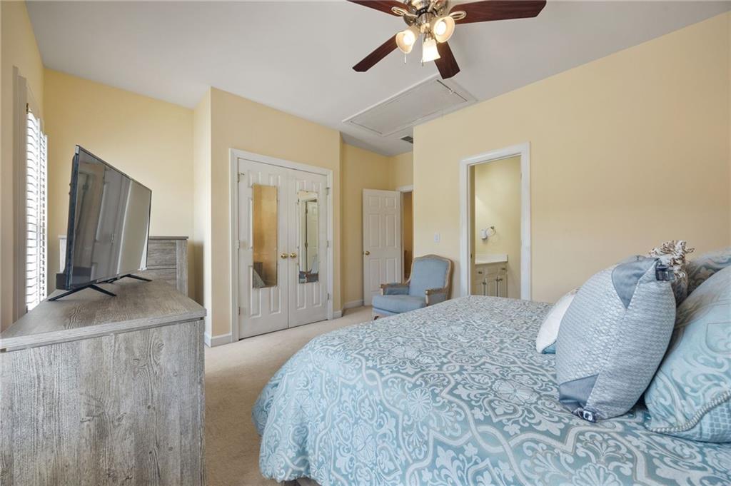 4727 Ivy Ridge Drive Southeast Atlanta, GA 30339 - Photo 21 of 35 a bedroom with a large bed and a chandelier