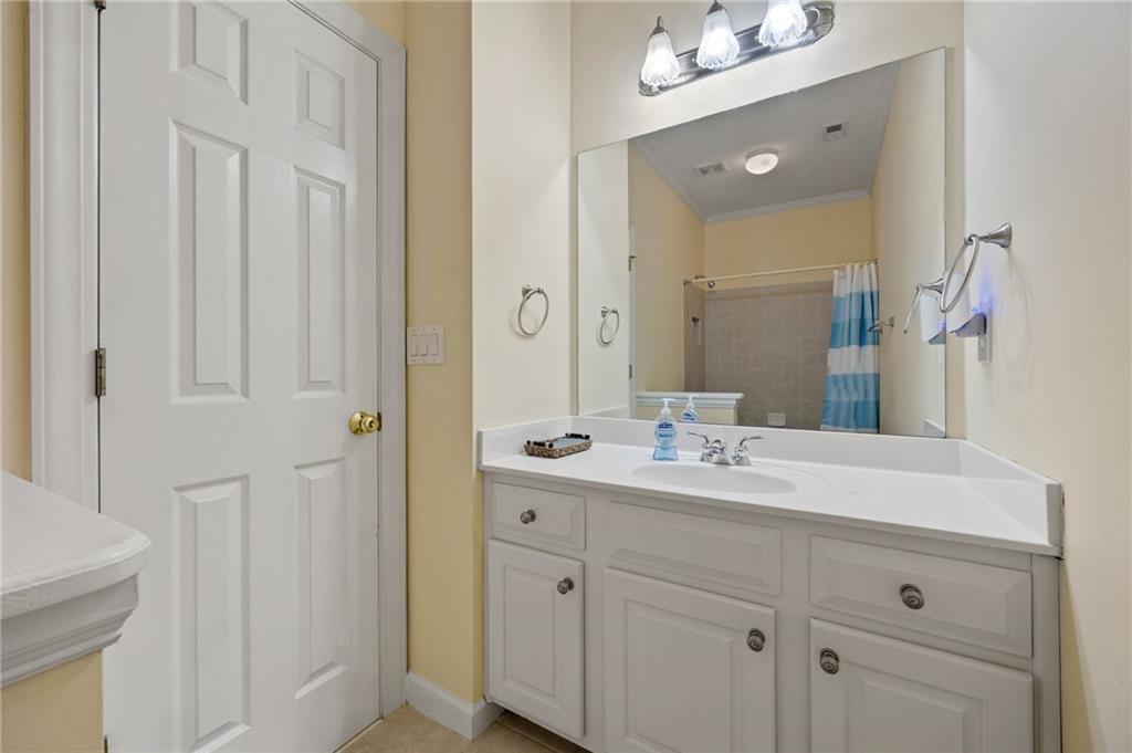 4727 Ivy Ridge Drive Southeast Atlanta, GA 30339 - Photo 22 of 35 a bathroom with a double vanity sink and mirror