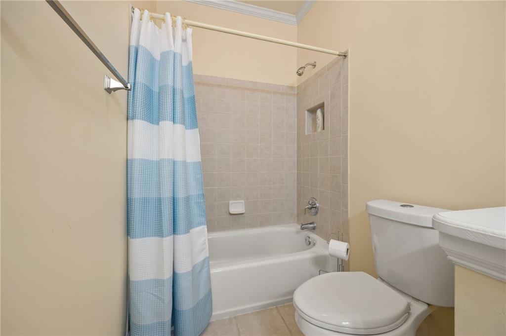 4727 Ivy Ridge Drive Southeast Atlanta, GA 30339 - Photo 23 of 35 a white toilet sitting next to a bath tub shower