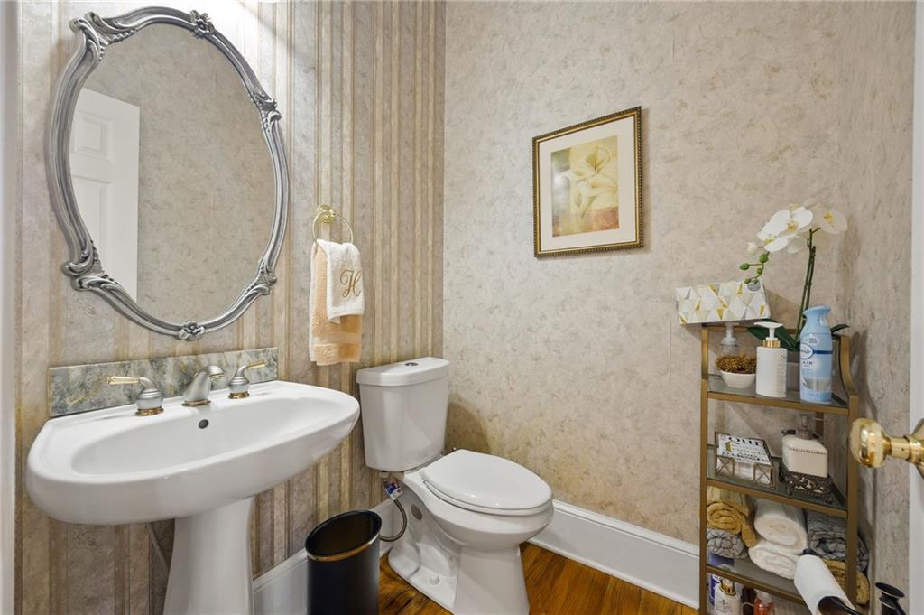 4727 Ivy Ridge Drive Southeast Atlanta, GA 30339 - Photo 10 of 35 a bathroom with a toilet sink and mirror