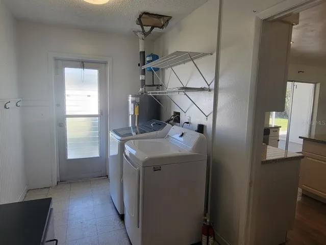 a utility room with closet dryer and washer