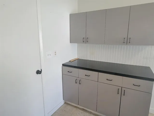a kitchen with white cabinets