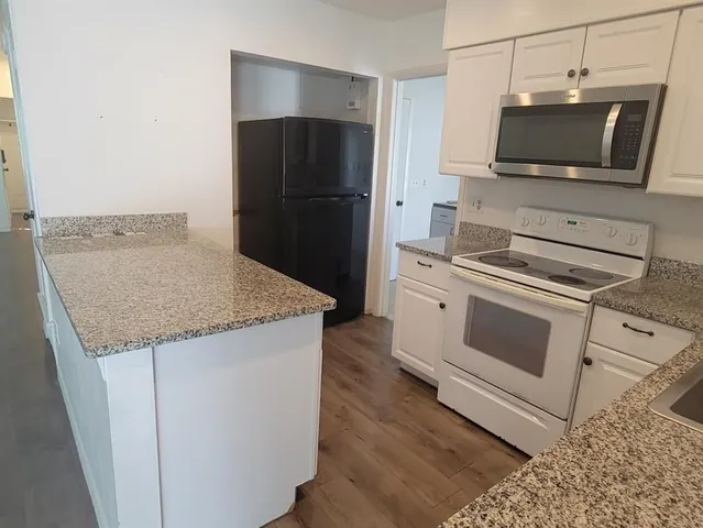a kitchen with a stove and a microwave
