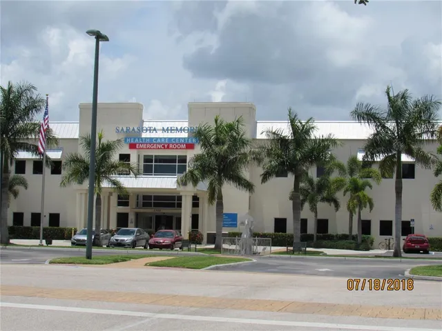 a front view of a building with tree s