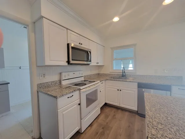 a kitchen with appliances cabinets and a sink