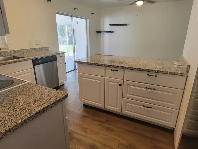 a kitchen with granite countertop cabinets and sink