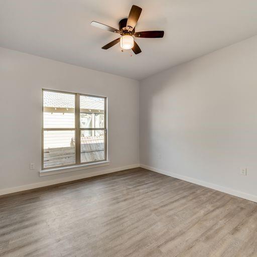 4337 Canal Street Dallas, TX 75210 - Photo 12 of 24 wooden floor in an empty room with a window