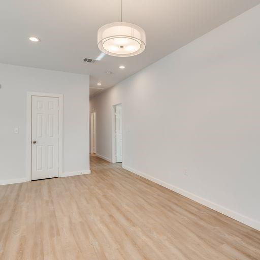 4337 Canal Street Dallas, TX 75210 - Photo 19 of 24 a view of an empty room with wooden floor