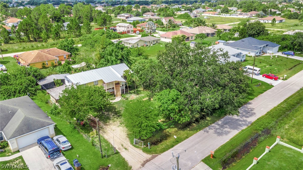 3809 4th Street Southwest Lehigh Acres, FL 33976 - Photo 2 of 34 an aerial view of residential houses with outdoor space