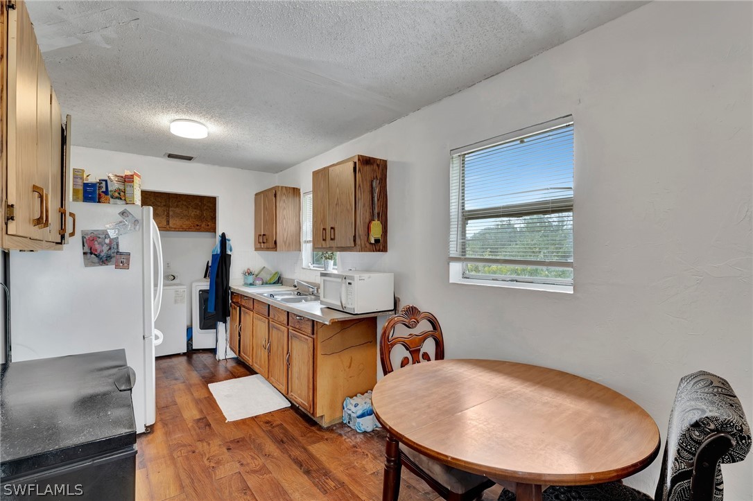 3809 4th Street Southwest Lehigh Acres, FL 33976 - Photo 21 of 34 a view of a dining room with furniture window and wooden floor