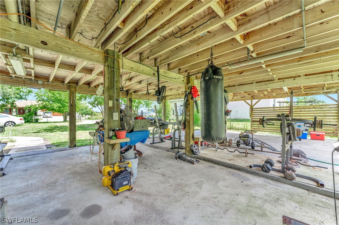 3809 4th Street Southwest Lehigh Acres, FL 33976 - Photo 30 of 34 a view of a room with gym equipment and floor to ceiling window