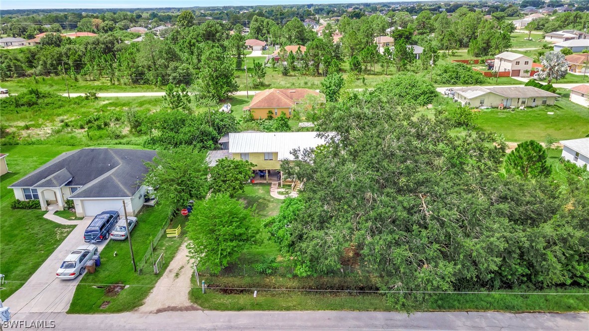 3809 4th Street Southwest Lehigh Acres, FL 33976 - Photo 3 of 34 an aerial view of residential houses with outdoor space and street view