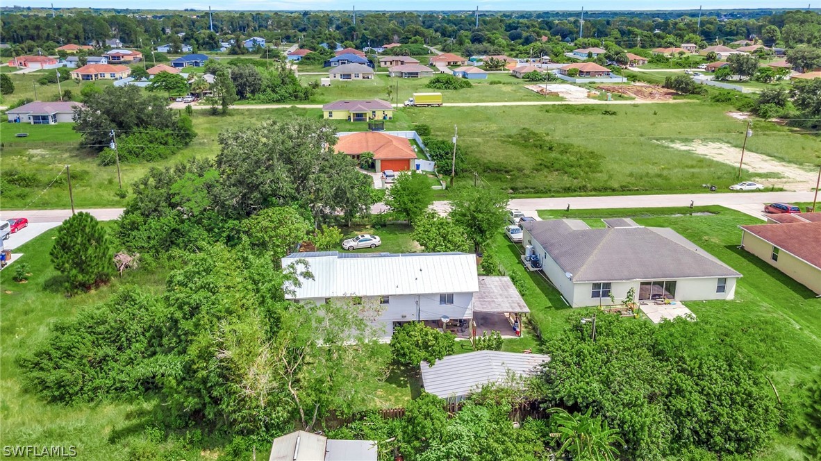 3809 4th Street Southwest Lehigh Acres, FL 33976 - Photo 4 of 34 an aerial view of residential houses with outdoor space and parking
