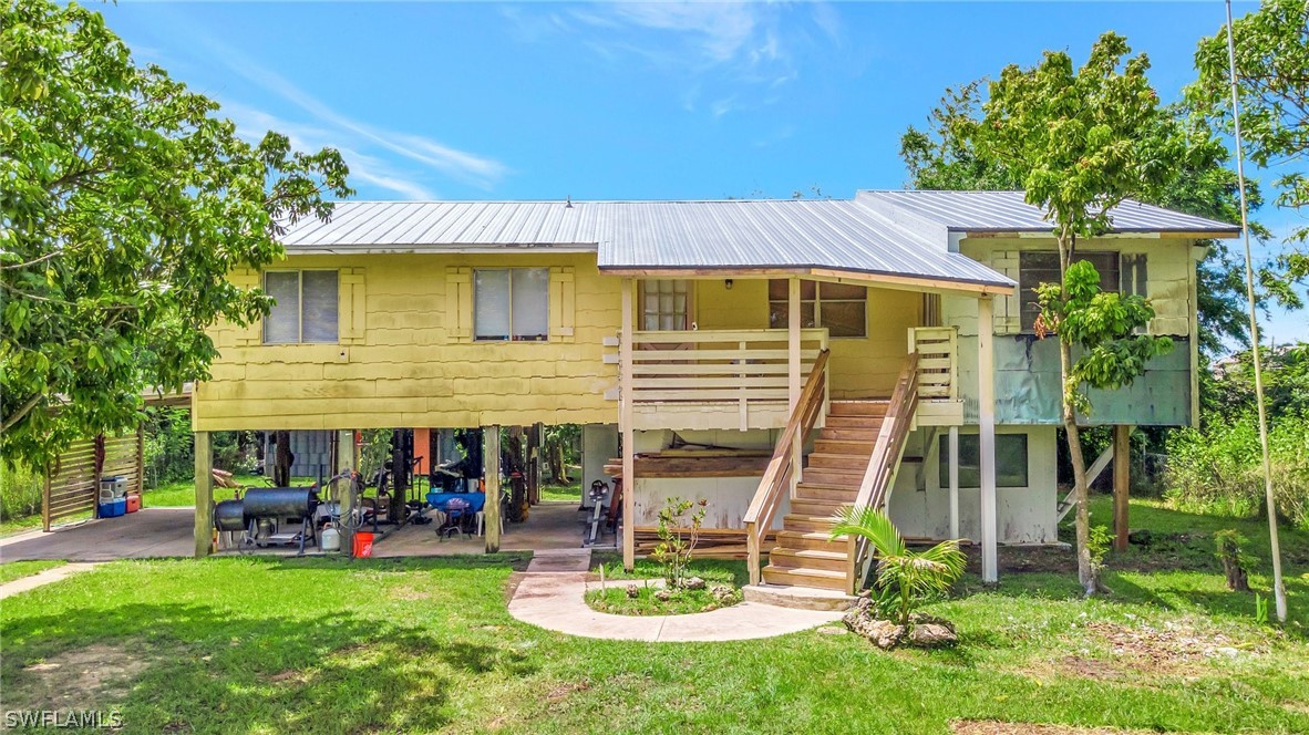3809 4th Street Southwest Lehigh Acres, FL 33976 - Photo 10 of 34 a view of a house with a yard porch and furniture
