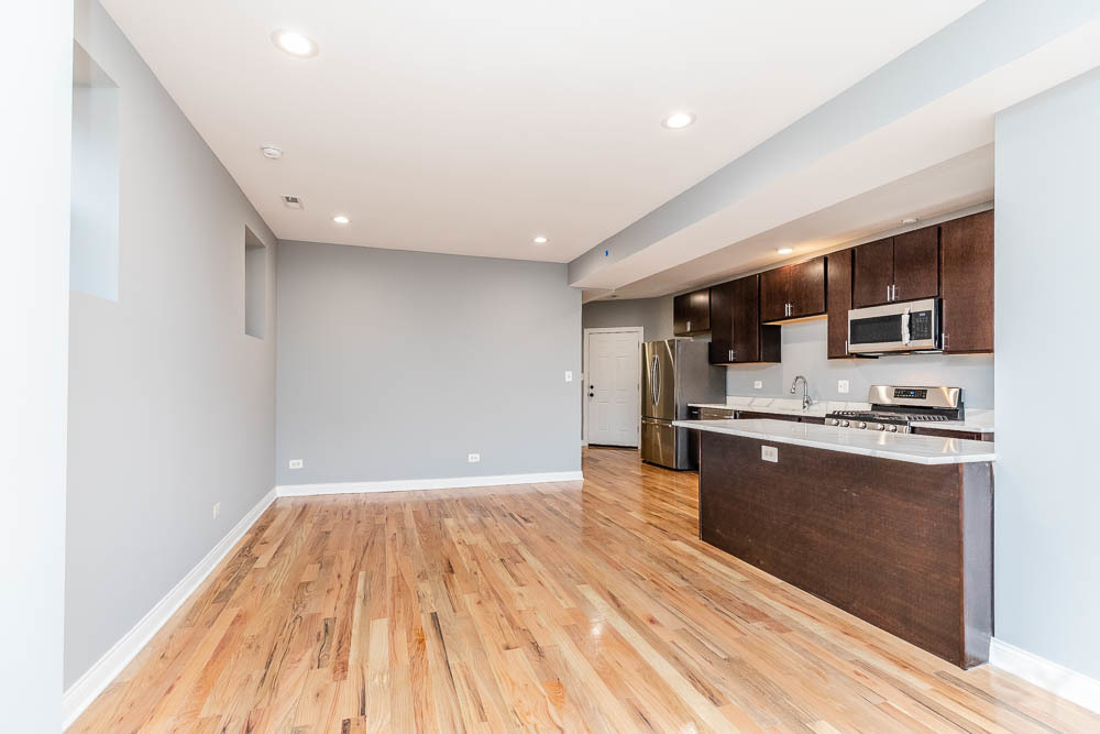 1411 East 67th Place, Unit 2W Chicago, IL 60637 - Photo 4 of 14 a kitchen with stainless steel appliances a refrigerator and a stove top oven