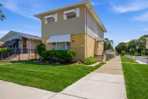 a front view of a house with a yard