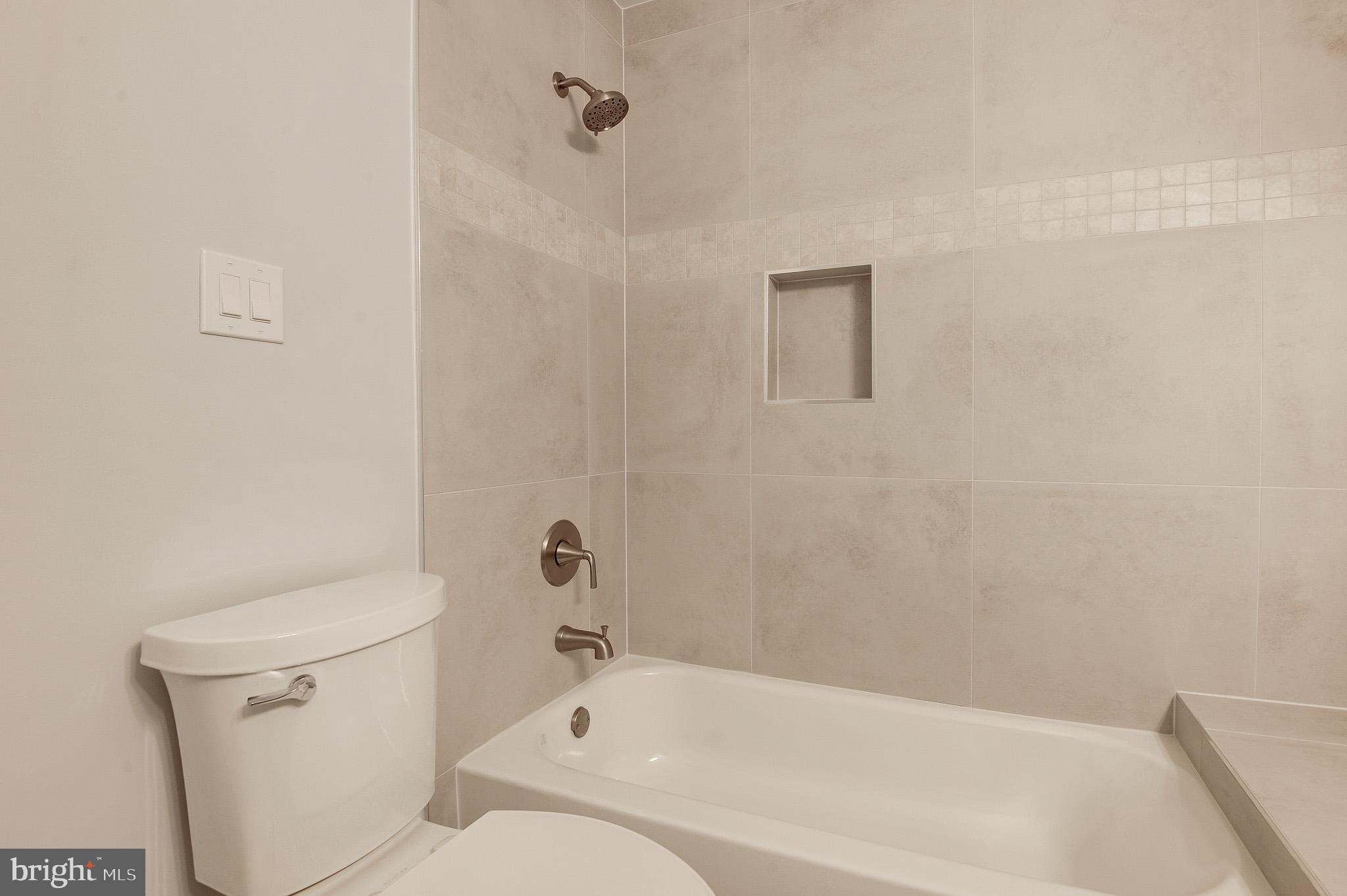 20600 Cornstalk Terrace, Unit 202 Ashburn, VA 20147 - Photo 21 of 31 a bathroom with a toilet and bathtub