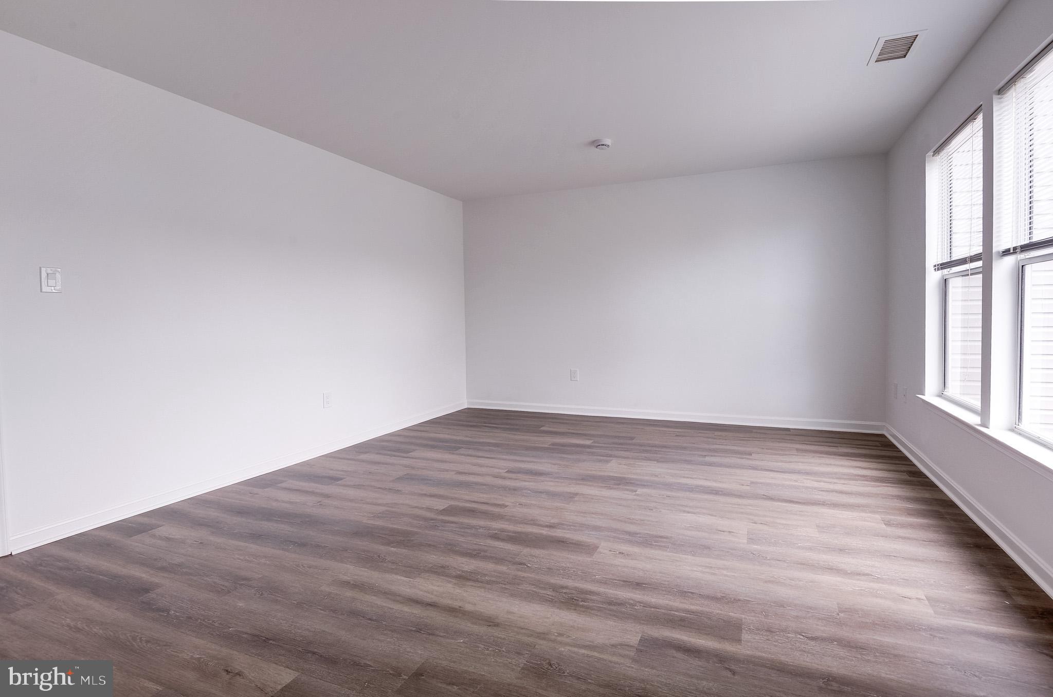 20600 Cornstalk Terrace, Unit 202 Ashburn, VA 20147 - Photo 25 of 31 wooden floor in an empty room with a window