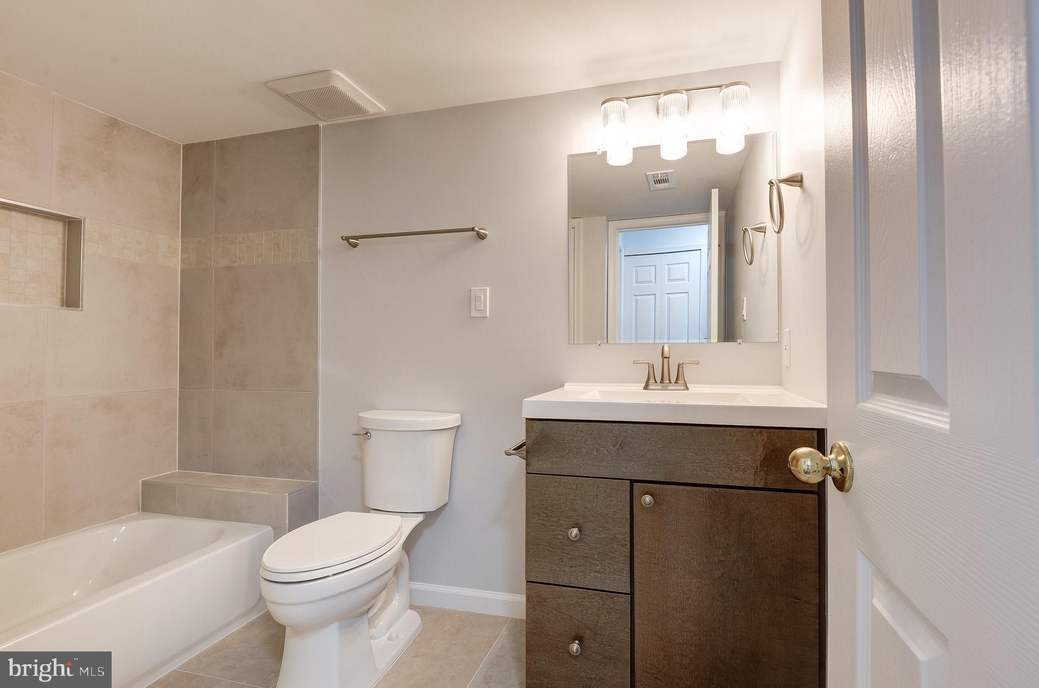 20600 Cornstalk Terrace, Unit 202 Ashburn, VA 20147 - Photo 30 of 31 a bathroom with a sink a toilet and shower