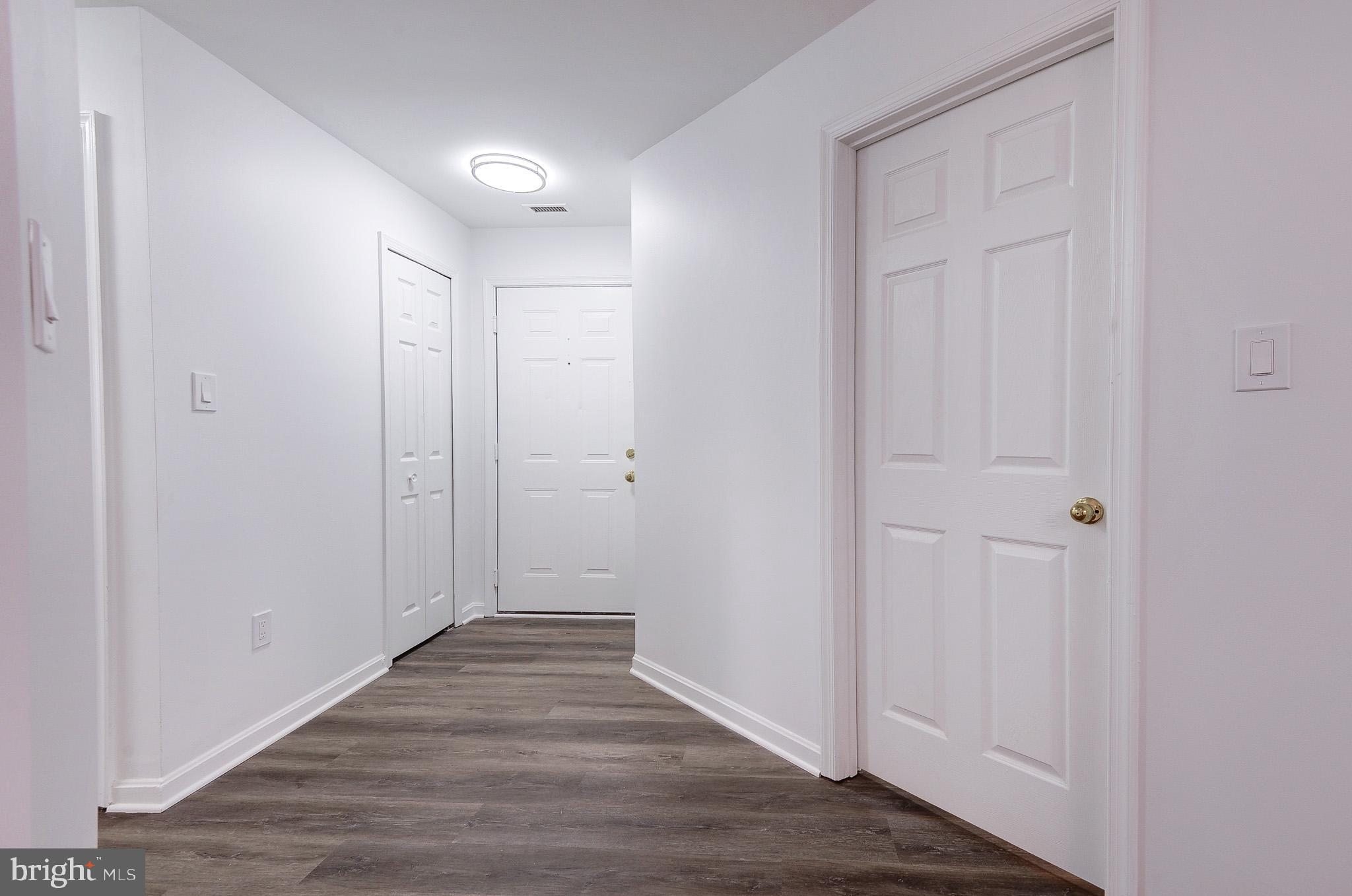 20600 Cornstalk Terrace, Unit 202 Ashburn, VA 20147 - Photo 3 of 31 a view of hallway with wooden floor