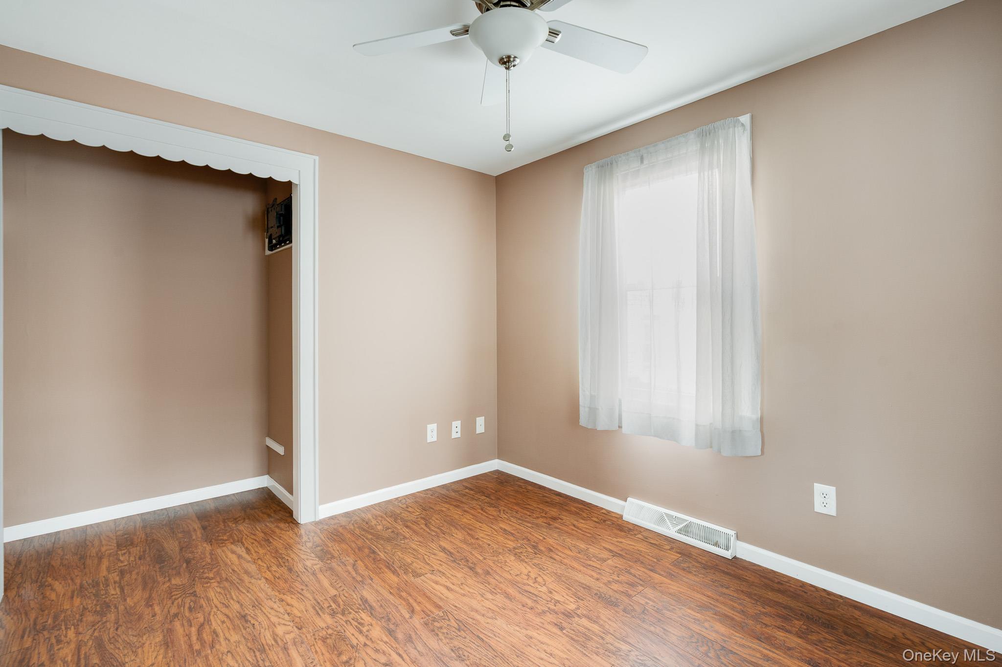36 Spruce Street Poughkeepsie, NY 12601 - Photo 12 of 30 a view of an empty room with window and wooden floor