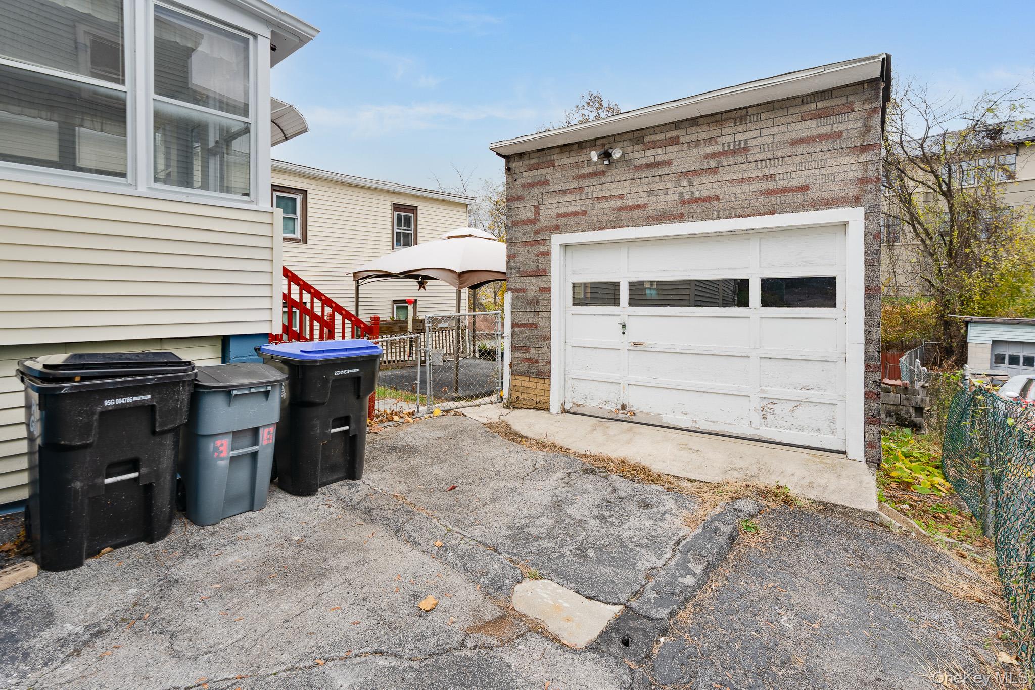 36 Spruce Street Poughkeepsie, NY 12601 - Photo 23 of 30 a view of a house with a barbeque and wooden fence