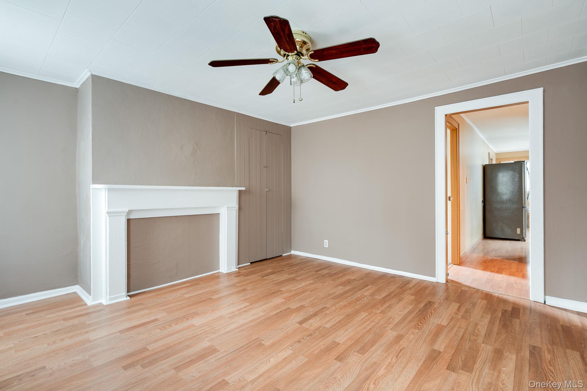 36 Spruce Street Poughkeepsie, NY 12601 - Photo 4 of 30 a view of empty room with wooden floor and ceiling fan