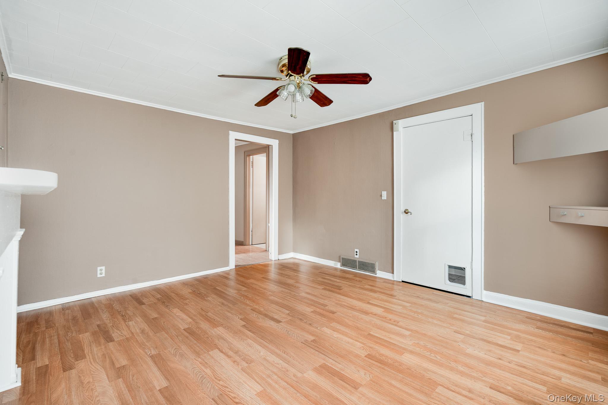 36 Spruce Street Poughkeepsie, NY 12601 - Photo 5 of 30 a view of an empty room with wooden floor and a ceiling fan