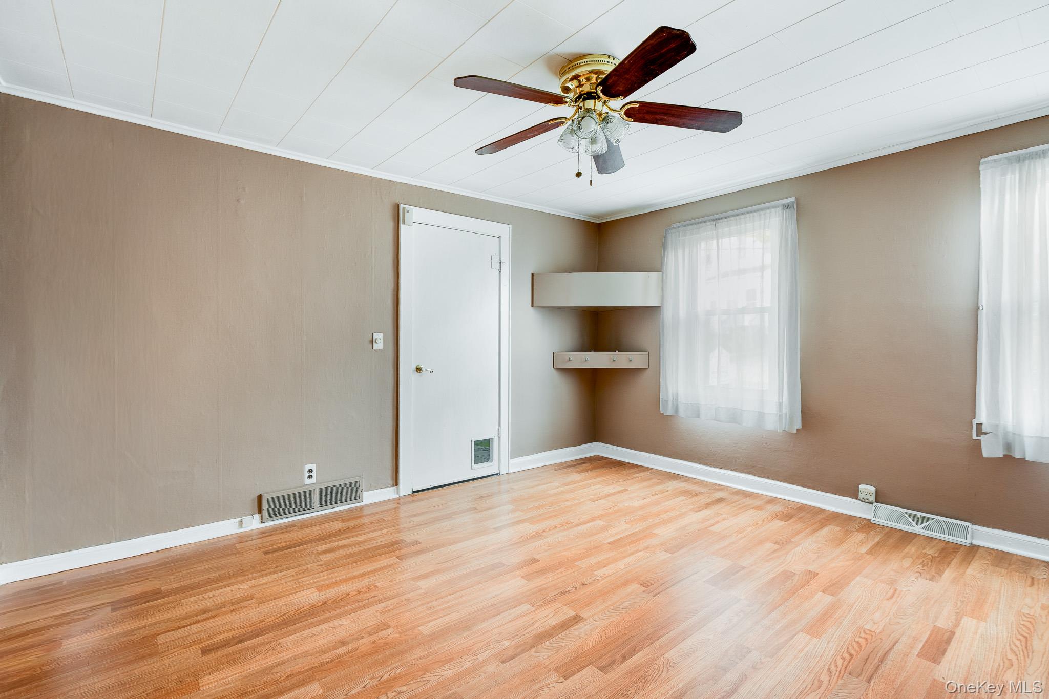 36 Spruce Street Poughkeepsie, NY 12601 - Photo 6 of 30 wooden floor in an empty room with a window