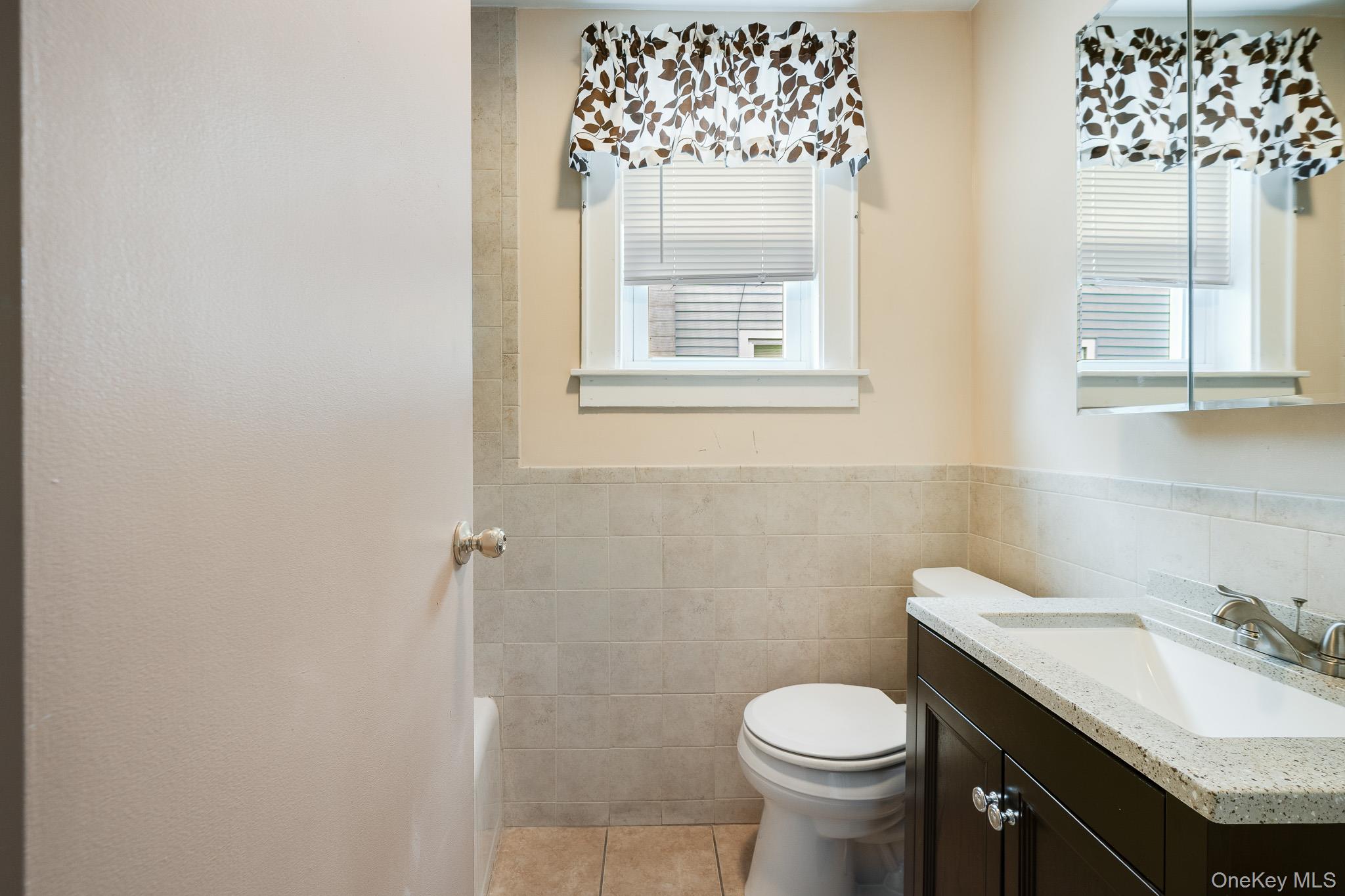 36 Spruce Street Poughkeepsie, NY 12601 - Photo 8 of 30 a bathroom with a granite countertop toilet and a sink