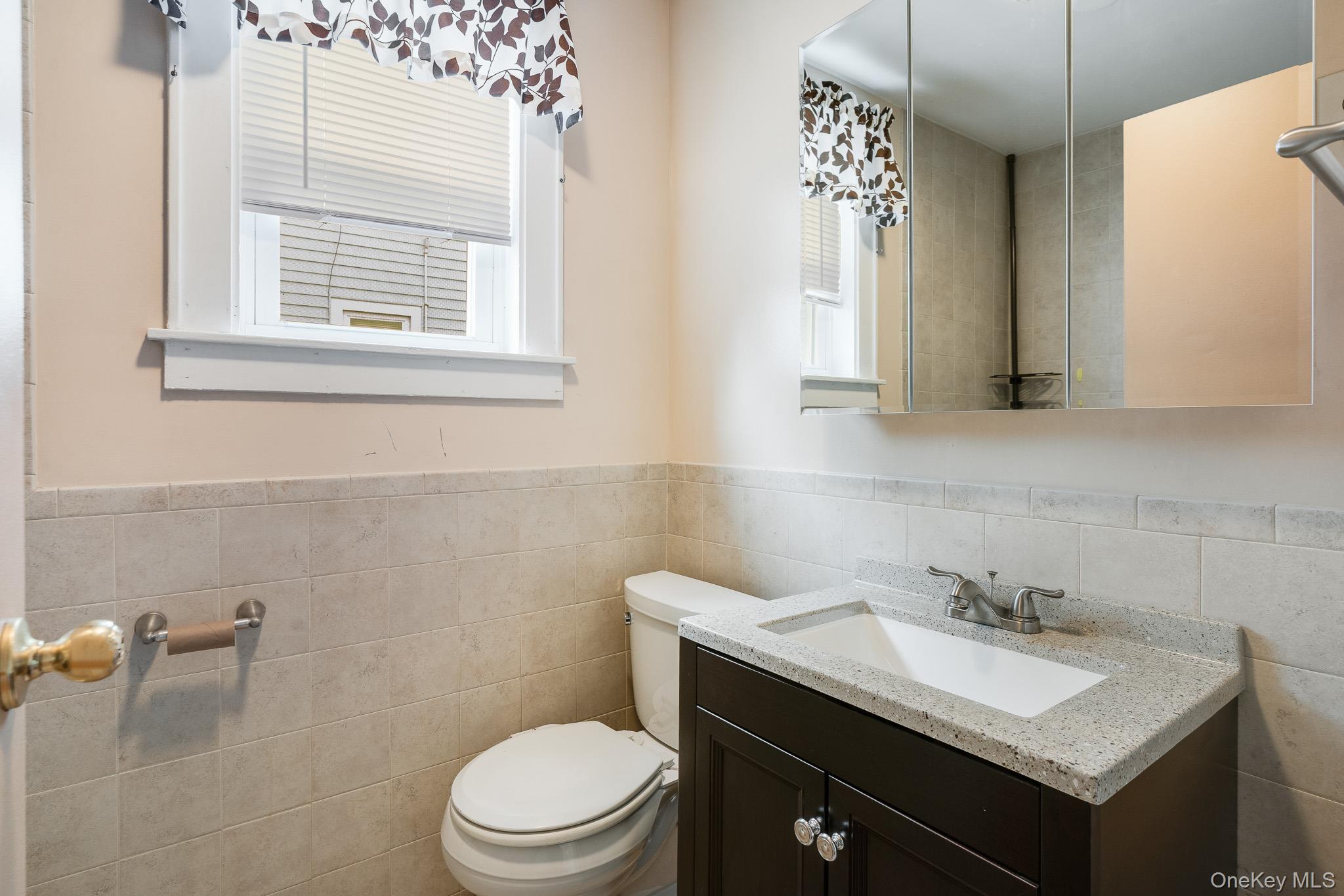 36 Spruce Street Poughkeepsie, NY 12601 - Photo 9 of 30 a bathroom with a sink a toilet and a mirror