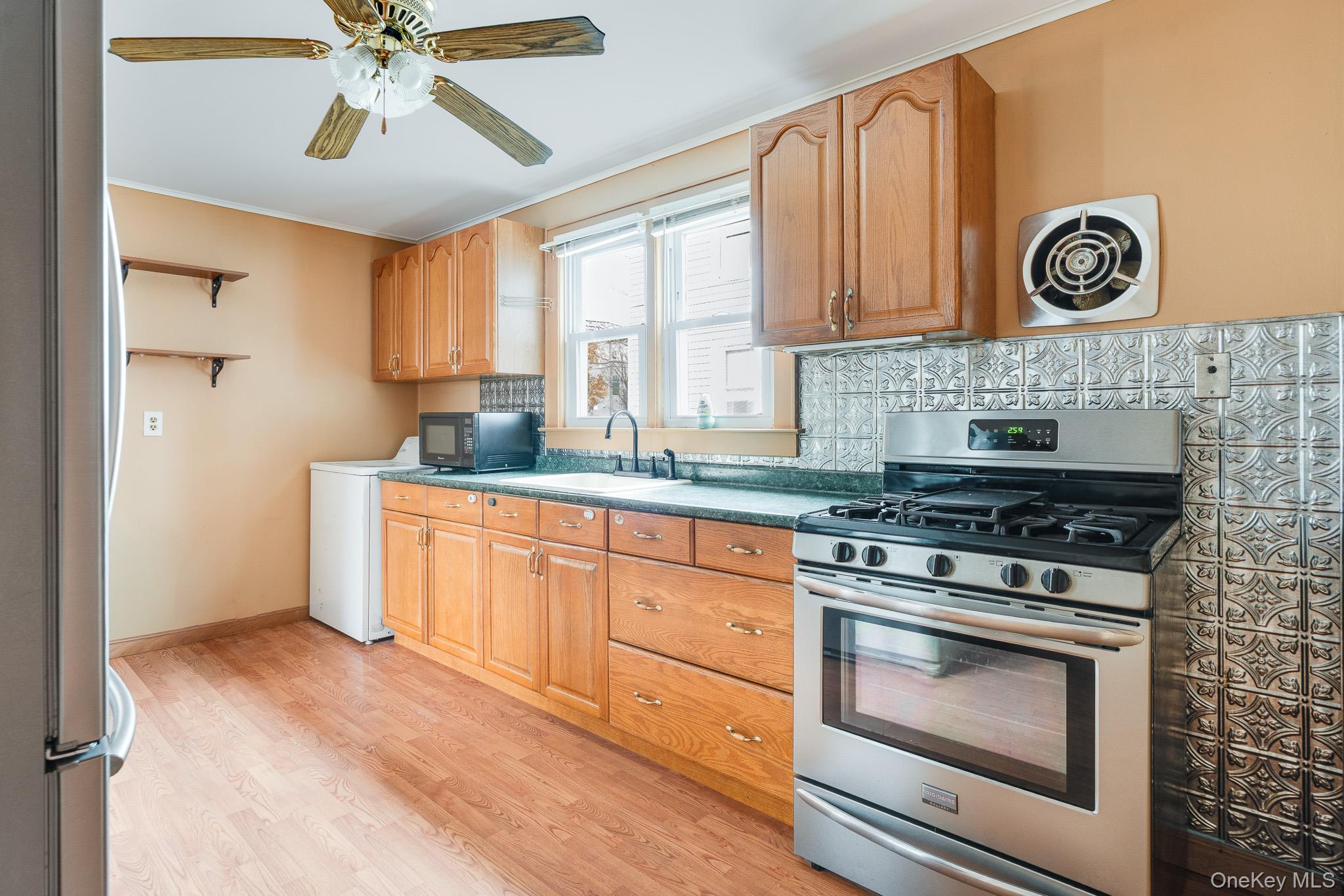36 Spruce Street Poughkeepsie, NY 12601 - Photo 10 of 30 a kitchen with a stove cabinets and window