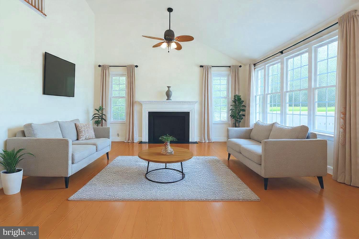a living room with furniture wooden floor and a fireplace