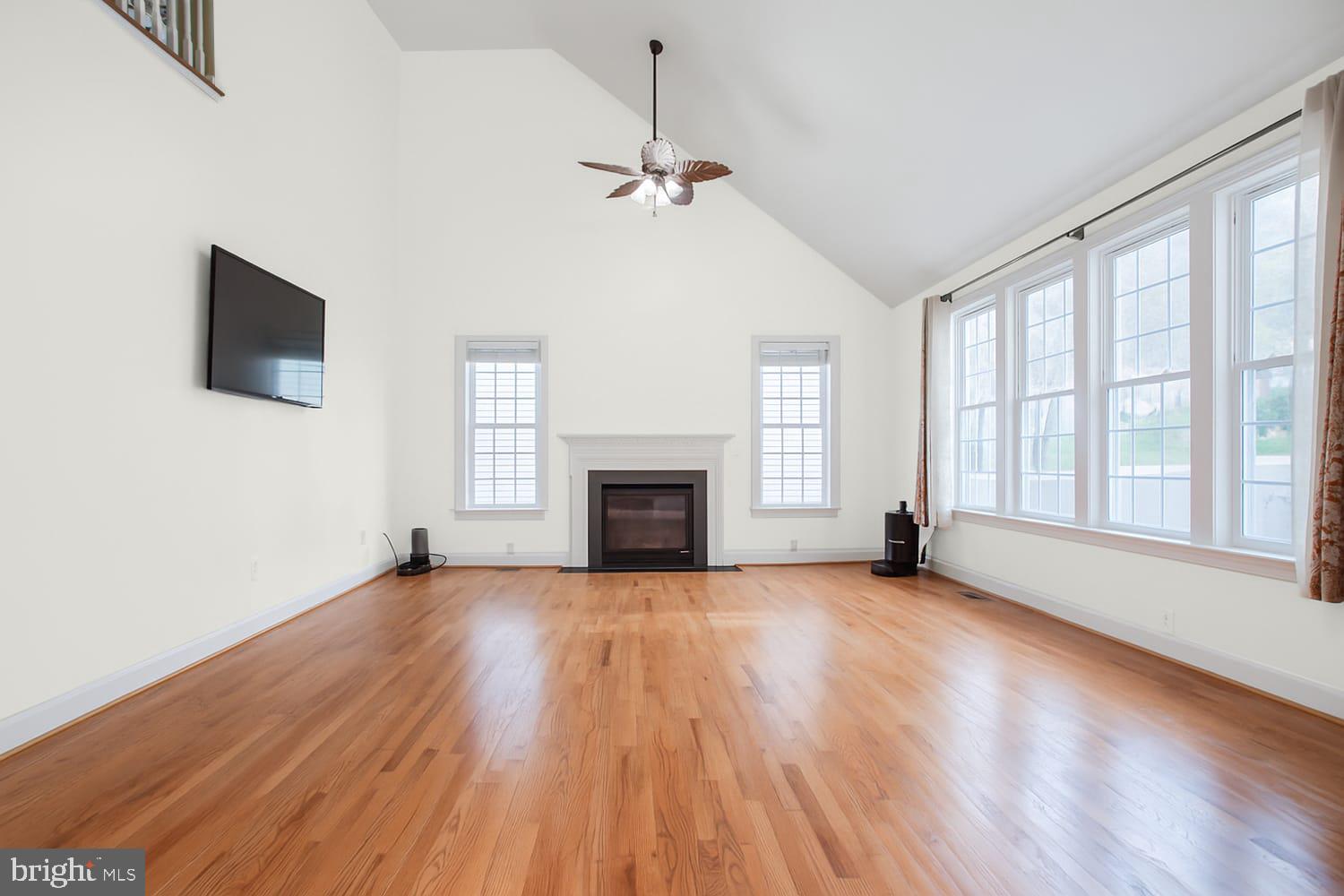 3403 Logstone Drive Triangle, VA 22172 - Photo 14 of 66 a view of an empty room with wooden floor fireplace and a window