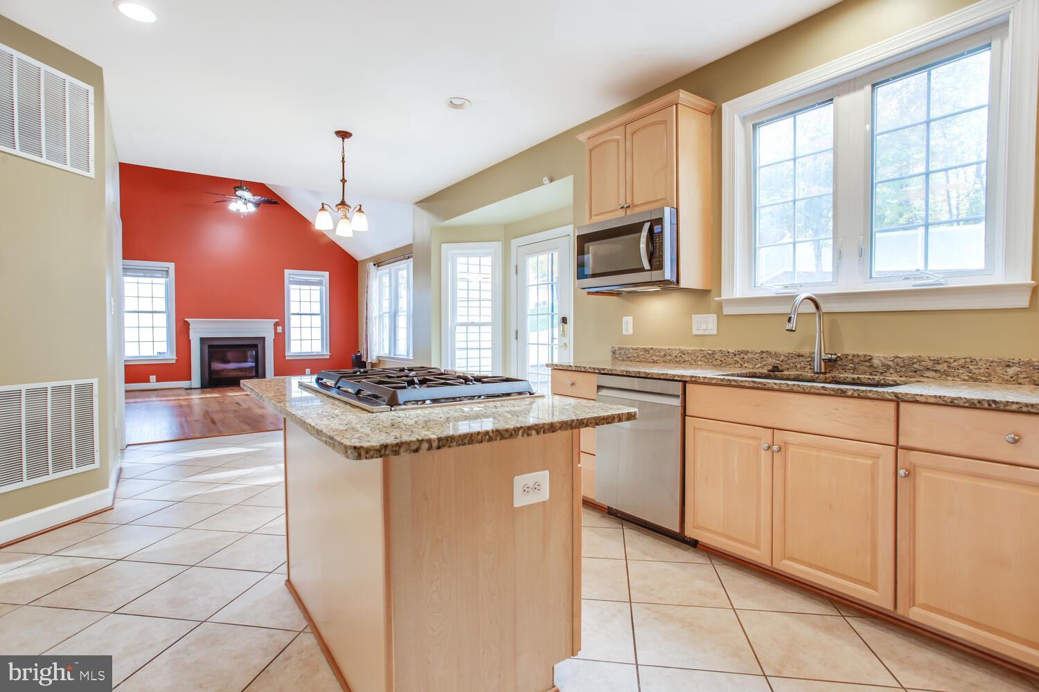 3403 Logstone Drive Triangle, VA 22172 - Photo 19 of 66 a kitchen with stainless steel appliances granite countertop a stove a sink and a microwave