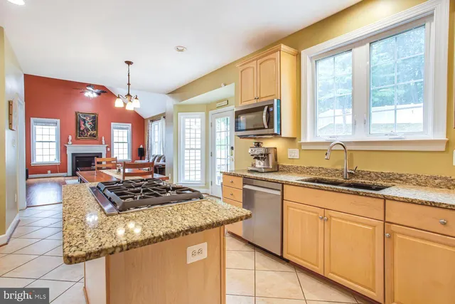 a view of an empty room with window and fireplace