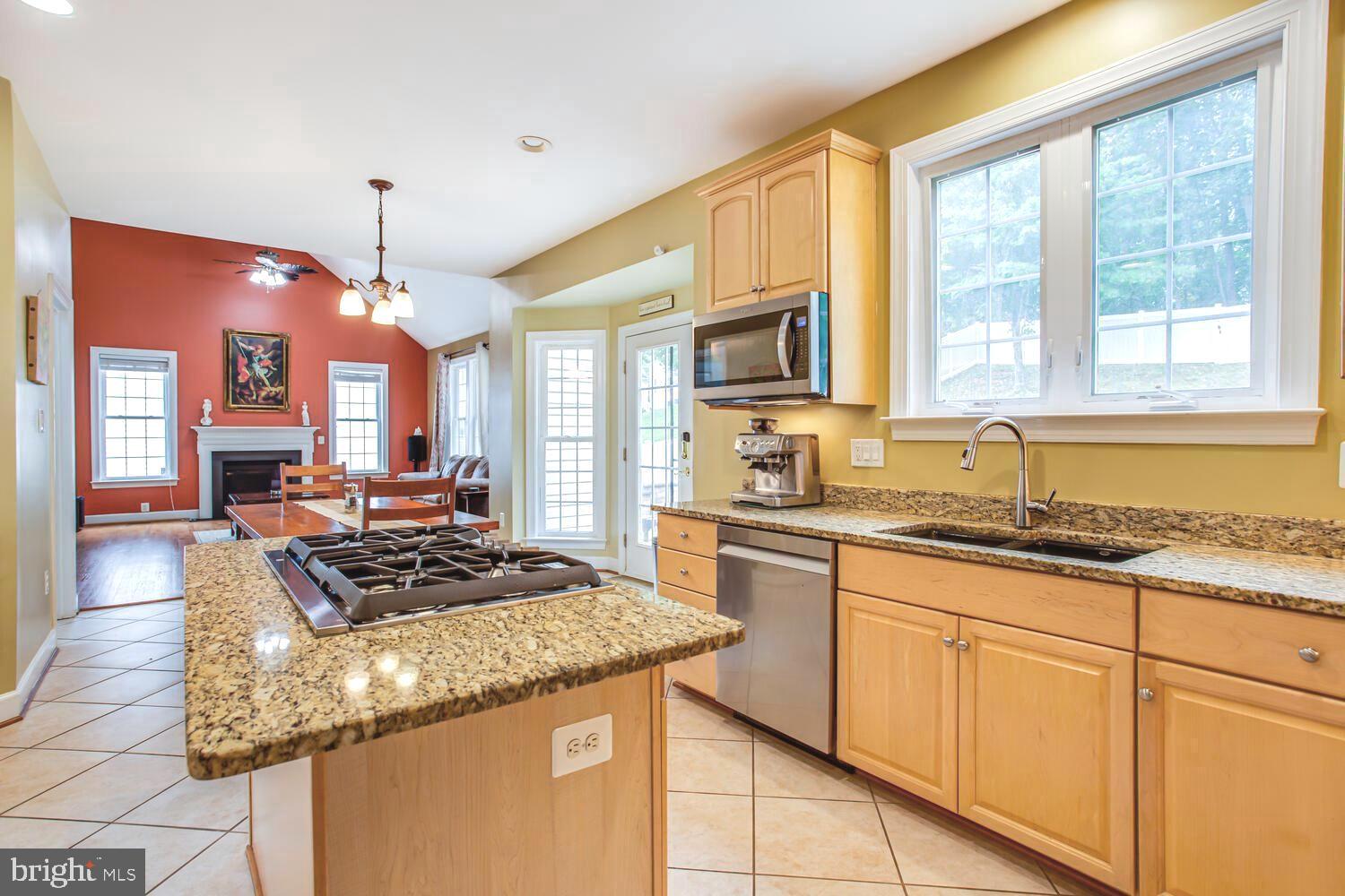 3403 Logstone Drive Triangle, VA 22172 - Photo 22 of 66 a kitchen with stainless steel appliances granite countertop a stove a sink and a refrigerator