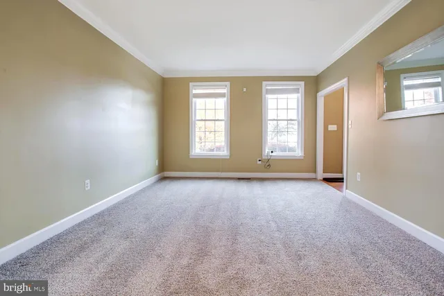a spacious bedroom with a bed and a chandelier