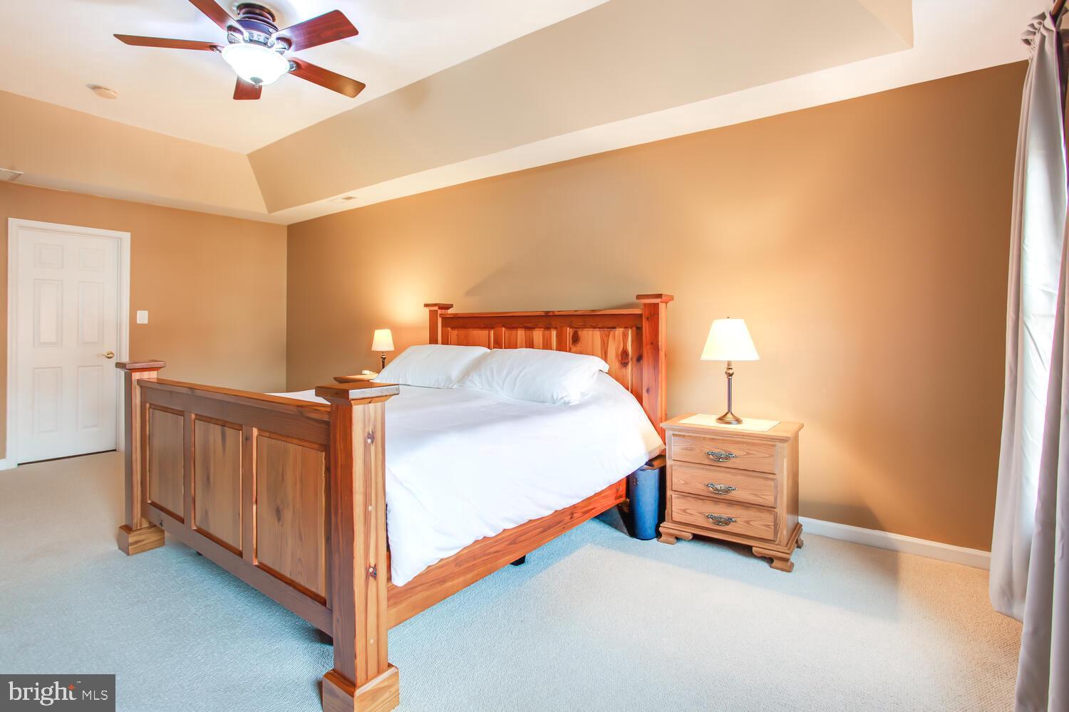 3403 Logstone Drive Triangle, VA 22172 - Photo 32 of 66 a spacious bedroom with a bed and a chandelier