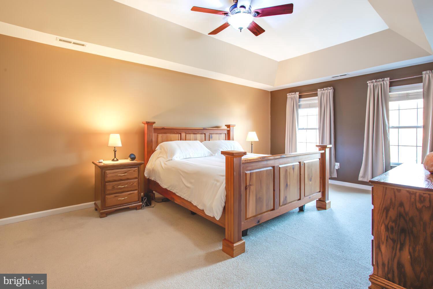 3403 Logstone Drive Triangle, VA 22172 - Photo 33 of 66 a bedroom with a bed and a chandelier